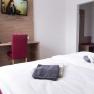 Double room, © W. Garhöfer Double room with bed, desk, chair and TV on the wall.
