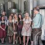 Winery Küssler, © Winzerhof Küssler Group of people in traditional dress in a winery.