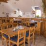 Winery Küssler, © Winzerhof Küssler Interior view of a cozy dining room with wooden furniture and decorations.