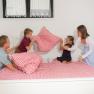 Winery Küssler, © Winzerhof Küssler Family having pillow fight on a bed with red and white checkered bedding.