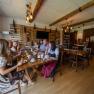 Winery Küssler, © Winzerhof Küssler Group of people in traditional dress sitting at a table in a rustic room.