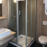 Amber Motel, © Bernstein Motel Modern bathroom with shower, washbasin and toilet.