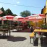 Terrace, © © GH Prinz Eugen Sunny terrace with wooden benches and red parasols.