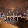 Winery Küssler, © Winzerhof Küssler Group of people sitting at a wooden table in a wine cellar.