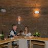 Winery Küssler, © Winzerhof Küssler A couple sits at a wooden table in a wine cellar and toasts with red wine.