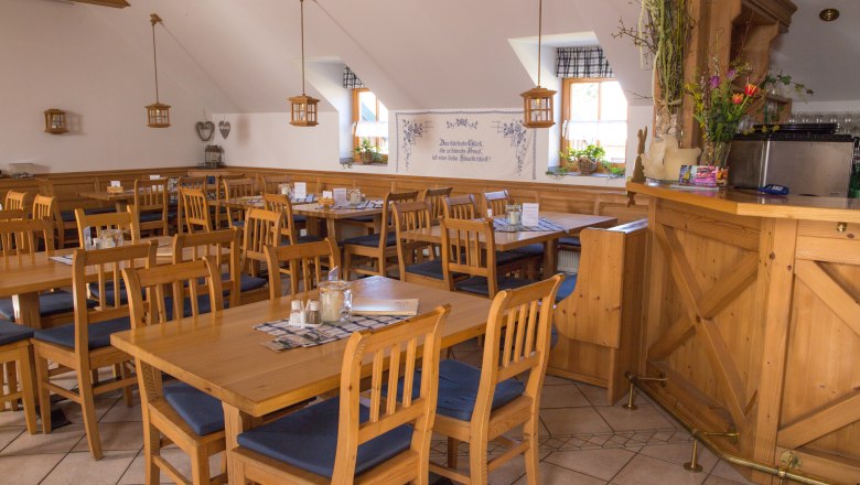 Cozy dining room with wooden furniture and decorations.