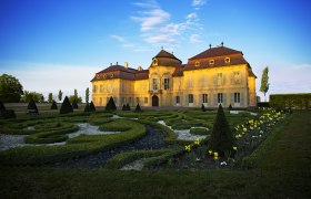Niederweiden Castle with well-tended garden in the foreground.