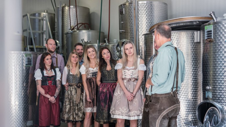 Group of people in traditional dress in a brewery.